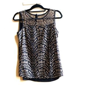 Top with a mesh neckline. Gold embroidery on black